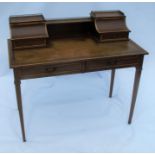 An Edwardian mahogany desk, fitted with cupboards and drawers to the back, with tooled leather inset