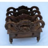 A 19th century mahogany Canterbury, with carved scroll and shell sections, fitted with a drawer,