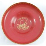A Royal Worcester shallow pedestal bowl, the red interior decorated with a gilt ship at sea, the
