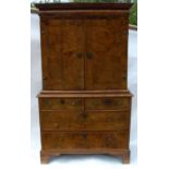An Antique walnut cabinet on chest, the upper section fitted with a frieze drawer over a pair of