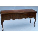 A reproduction mahogany and burrwood dresser base, fitted with four short drawers over a curved
