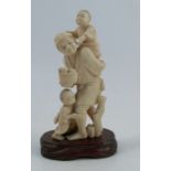 A 19th century carved ivory Oriental figure, of a man with two children and a basket of fruit,