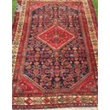 An Eastern design rug, with central diamond to the field and repeating motifs, 72ins x 45ins,