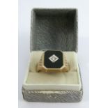 A 9 carat gold diamond set onyx signet ring, finger size W, 7.9g gross