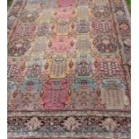 An Eastern style rug, the large field decorated with urns of flowers, 90ins x 62ins