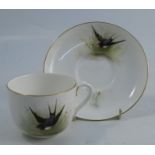 A Royal Worcester cup and saucer, decorated with swallows by W Powell, inscribed to underside, dated