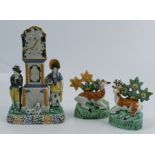 A 19th century Pratt ware Staffordshire pearlware money box, formed as a long case clock flanked