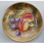 A Royal Worcester circular dish, decorated with fruit to a mossy background by Roberts, diameter 4.