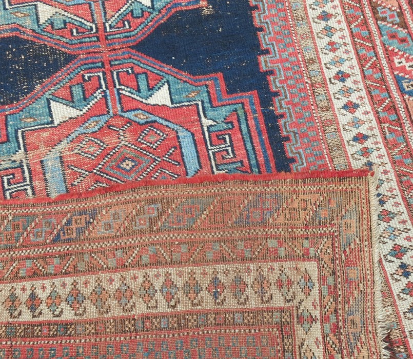 An Eastern design rug, the field with three motifs to a dark blue ground, 73ins x 48ins - Image 3 of 3
