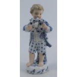 A 19th century Meissen figure, of a boy standing and holding a floral chaplet, with a lace-trimmed