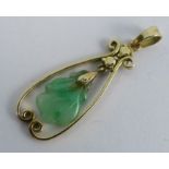 A carved jade pendant, hanging within a wire frame stamped 'Manning 585', 3.6cm long overall