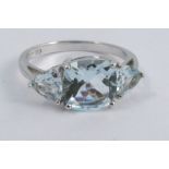 A 9ct white gold three stone aquamarine ring, finger size O, 2.5g gross, cased