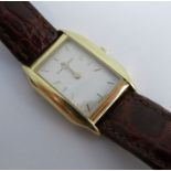 Baume & Mercier, a ladies wrist watch of tonneau shape, the signed white dial with gilt batons and