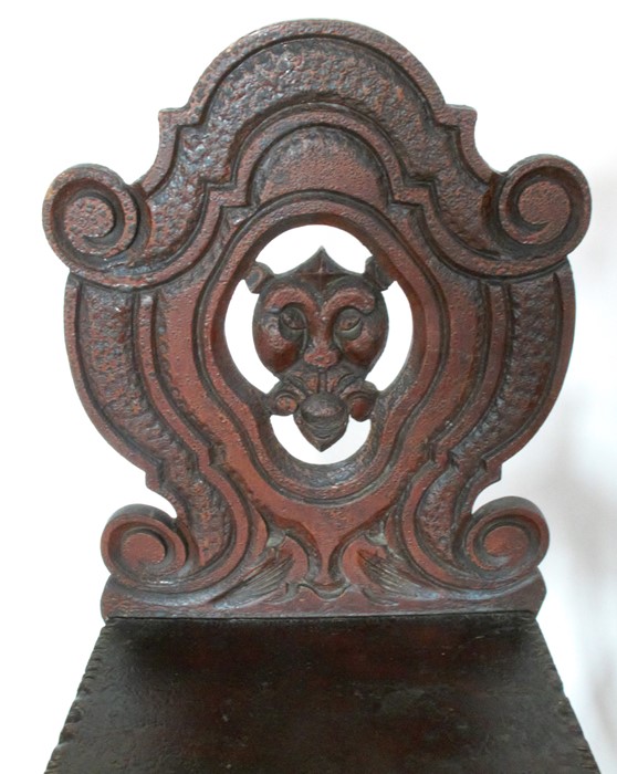 A pair of 19th century hall chairs, the shield shaped back carved with a mask, having solid seats - Image 2 of 3