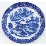 A First Period Worcester blue and white dish, decorated with a version of the Willow pattern,