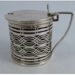 A silver mustard pot, of pierced cylindrical design, with blue glass liner, Birmingham 1899,