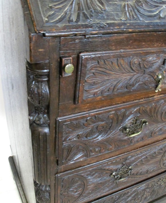 An Antique dark oak carved bureau, the fall flap opening to reveal drawers, cupboard and pigeon - Image 4 of 4
