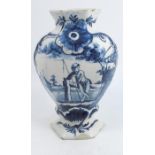 An 18th century Dutch Delft vase, by De Porcelyne Claeuw factory, painted with a man in a garden, ‘