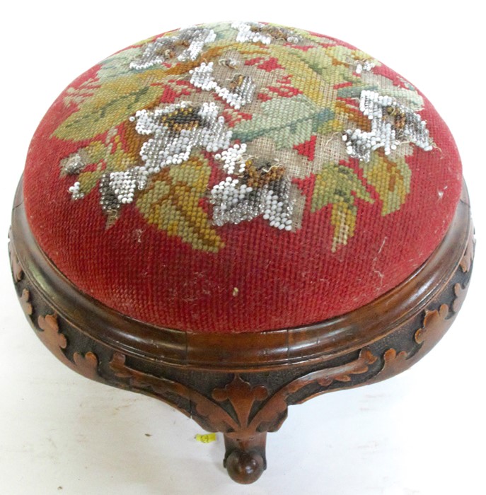 A 19th century mahogany framed foot stool, with bead work and tapestry top, and carving to the