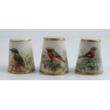 Three Royal Worcester thimbles, all painted with British birds, all signed by Powell, one without