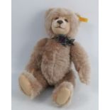 A modern Steiff teddy bear, makes a sound when shaken, height 14ins, together with Steiff paper bag