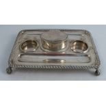 A Victorian silver desk stand, of rectangular form with gadrooned edge, to pen wells, recesses for