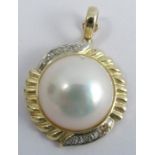 A Mabe pearl and diamond pendant, stamped '14k 585', the 15mm pearl with four single  cuts above and