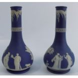 A pair of 19th century Wedgwood jasper ware vases, decorated in the Classical style, height 7.