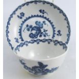 A First period Worcester tea bowl and saucer, decorated in the blue and white fruit and wreath