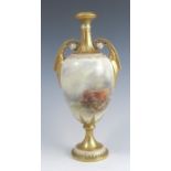 A Royal Worcester pedestal vase, having a pair of gilt scroll handles and fluted gilt neck, the