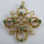 An 18 carat gold diamond and emerald pendant brooch, set with eight small brilliant cuts totalling