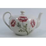 A MacIntyre Burslem teapot, designed by Moorcroft, decorated with pink flowers to a white ground,