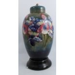 A Moorcroft pottery lamp base, formed as a ginger jar and cover, decorated in the Orchid pattern, on