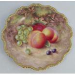 A Royal Worcester cabinet plate, decorated with fruit to a mossy background by H Aryton, with gilded