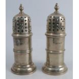 A pair of silver sugar casters, with reeded cylindrical bodies, London 1931, weight 9oz, height