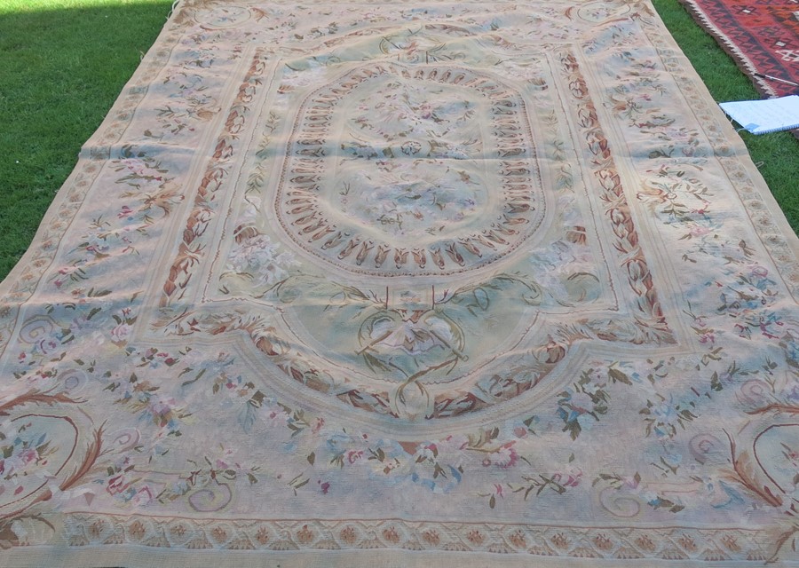 A French Aubusson style rug, decorated in the Classical style with flowers and foliage, 80ins x