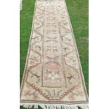 An Eastern design runner, decorated with lozenges and flowers to the field, 31ins x 108ins