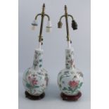 A pair of Oriental design table lamps, of bulbous form, decorated with flowers and insects on a