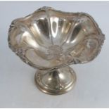 A silver pedestal bowl, with shaped edge and embossed decoration, Sheffield 1905, weight 8oz