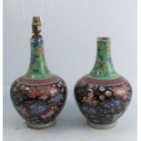 A pair of Chinese vases, decorated with foliage to a green and black ground, cut down and af, height