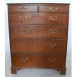 A 19th century oak chest, of two short over four long graduated drawers, raised on bracket feet,