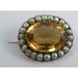 A Victorian citrine and seed pearl oval gold brooch, unmarked, 2.1cm by 1.8cm, 4.7g gross