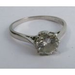 A solitaire diamond ring, the white mount stamped 18ct, the brilliant cut measuring approximately
