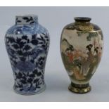 An Oriental blue and white baluster vase, decorated with two four toed dragons and foliage,