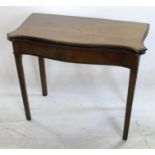 A George III mahogany serpentine fold over card table, raised on fluted legs, 33ins x 28ins