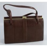 A Mappin & Webb brown leather handbag, with suede interior and gilt metal mounts, 7ins x 10ins