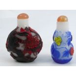 Two 20th century Chinese four colour cameo glass snuff bottles, one of moon shape carved with