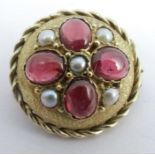 A Victorian gold garnet and seed pearl brooch, unmarked, 21mm diameter, 3.8g gross