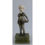 An Austrian Art Deco model, of a young girl holding her skirt with finger to her mouth, in ivory and