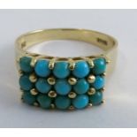 A fifteen stone turquoise set ring stamped '750', finger size Q, 4.4g gross